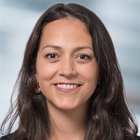 Close-up of Nathalie Giroud smiling and wearing earrings