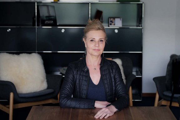 Woman in black jacket sitting at a table