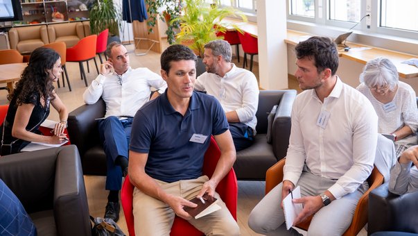 Participants discuss in a round-table